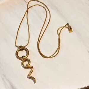 Anne helping gold to e long statement necklace